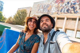 Selfie of a tourist couple visiting the National Historical Museum in Skanderbeg Square in Tirana. Albania