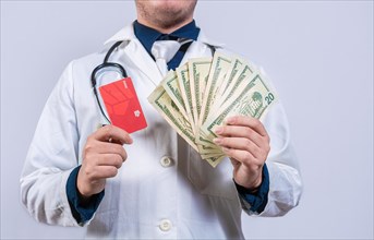Doctor hands holding credit card and money isolated. Unrecognizable doctor holding money and credit cards isolated