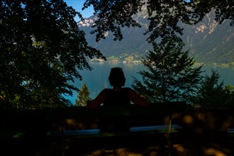 Woman Sitting on a Bench and Enjoy the View over Lake Brienz with Mountain in Giessbach in Brienz