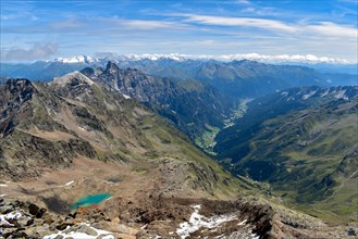 A glacial lake above the Pflerschtal valley with the Pflerscher Tribulaun and the Zillertaler Alps on the horizon