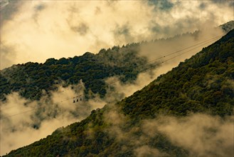 Mountain Cable Car with Clouds and Sunlight in Miglieglia