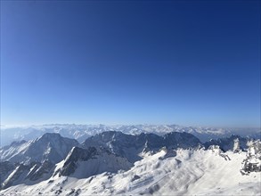 Bloick from the Zugspitze summit on ski lifts and main Alpine chain