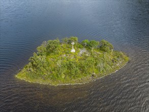 Aerial view of a small island with a Celtic stone cross in the freshwater loch of Loch Stack in the Northern Highlands