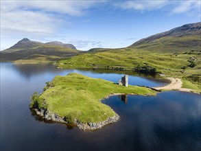 Aerial view of the freshwater loch Loch Assynt with the ruins of Ardvreck Castle on a peninsula