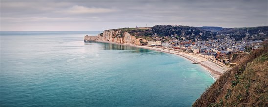 Wonderful panoramic view to the Etretat village and beach resort from the famous Falaise d'Aval cliffs in Normandy