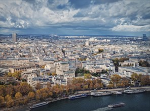 Paris city aerial sightseeing view over the Seine river. Beautiful seasonal panorama with colorful autumn trees