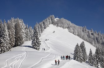 Deep snowy winter landscape with ski tourers on the way to the Zwoelferhorn