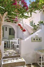 Traditional Greek patio or outdoor cafe with white walls
