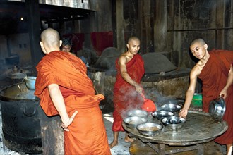 Monks cook food in monastery school of Bago