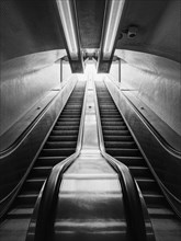 Subway escalator black and white architectural details. Symmetrical underground moving staircase
