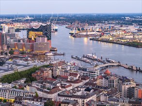 Aerial view of Hamburg harbour at blue hour with Landungsbruecken and Elbe Philharmonic Hall