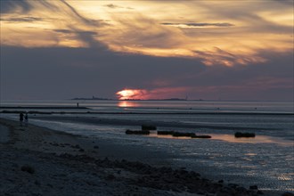 Dramatic sunset over the mudflats at low tide on the beach of Cuxhaven