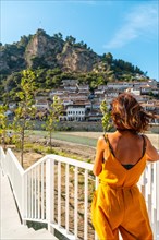 A tourist woman looking at the historic city of Berat in Albania enjoying the vacation