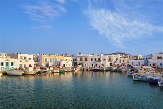 Traditional Greek fishing village and harbour on sunny day