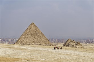 Camel guides and camels in front of the Mykerinos Pyramid and the Queen's Pyramids