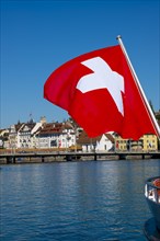 Swiss Flag in City of Lucerne with Lake in a Sunny Summer Day in Lucerne