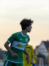 Young football player running across the pitch