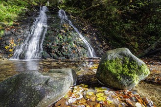 Mountain stream and waterfall in autumn forest