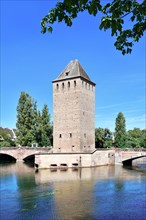Historical tower of 'Ponts Couvert' bridge as part of defensive work erected in the 13th century on the River Ill in 'Petite France' quarter of Strasbourg city