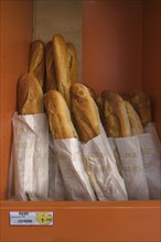 Fresh baguettes in a bread box of a bakery