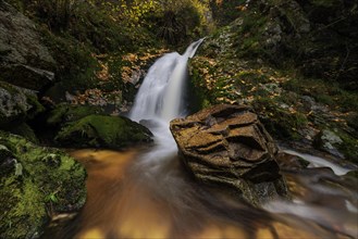 Mountain stream with waterfalls in autumn