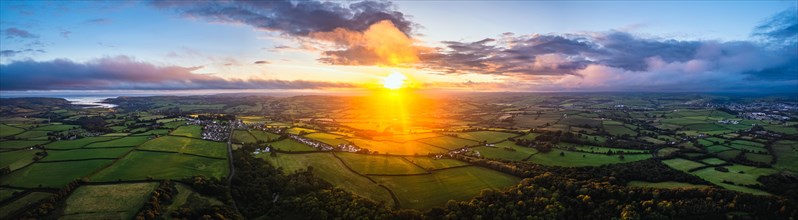 Panorama of Sunset over Fields and Farms from a drone