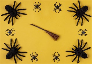 Black spiders with witch's broom on yellow
