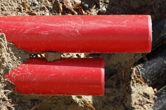 Red pipes in the sand on a construction site
