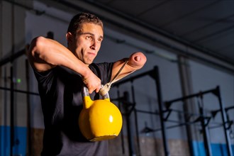 Conceptual portrait of a man with no barriers for a handicapped man training on a gym