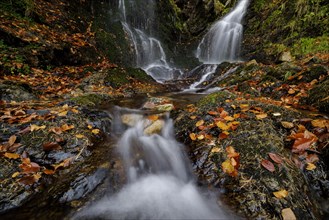 Mountain stream and waterfall in autumn forest