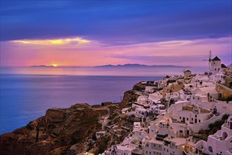 Beautiful view of Oia village with traditional whitewashed houses and windmills