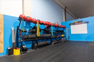 Rack with medicinal balls and weights in a cross training gym without people