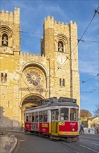 Tram passes by Lisbon Se Cathedral