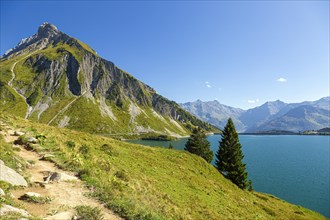 The Spullersee high mountain lake in Vorarlberg with a view of the Goppelspitz mountain