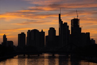 Clouds pass over the silhouette of Frankfurt's banking skyline in the evening after sunset