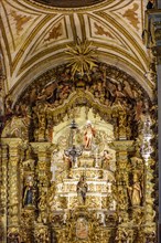 Old altar of a historic baroque church completely covered in gold in Ouro Preto