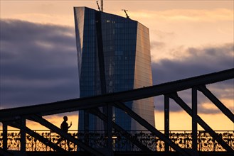 The sun rises behind the European Central Bank