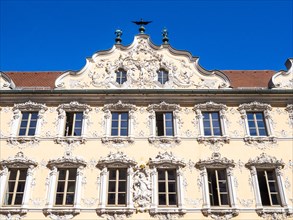 Facade view of the Falkenhaus with stucco facade in rococo style in the centre of Wuerzburg