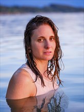 Young woman with wet long hair in the water