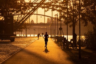 A jogger runs along Frankfurt am Main shortly after sunrise