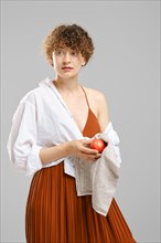 Woman wiping an apple with a towel. Concept of healthy eating