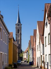 Alley with church tower and old houses