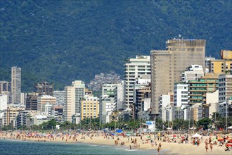 Summer day in the city of Rio de Janeiro with Ipanema beach occupied by city residents and tourists