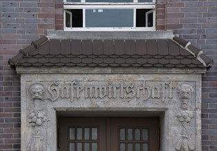 Lettering on a heritage-protected building commemorates its former use as a port economy