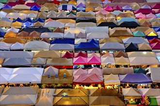Colorful market tents at sunset. Fairs and marketplaces