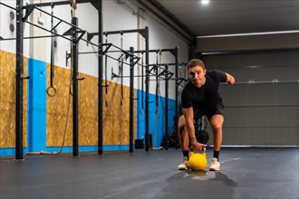 Photo with copy space of a disabled man with an arm amputated training with a kettlebell