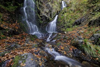 Mountain stream and waterfall in autumn forest