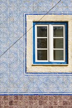 Traditional azulejo wall tiles and window
