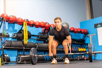 Portrait of a disabled man dead lifting with an amputated arm