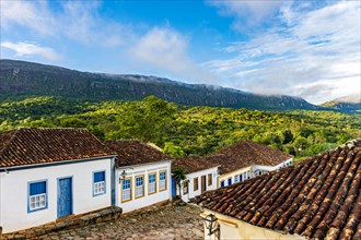 Quiet street in the historic city of Tiradentes with its old colonial-style houses and the mountain in the background